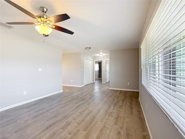 empty room with light hardwood / wood-style flooring and ceiling fan
