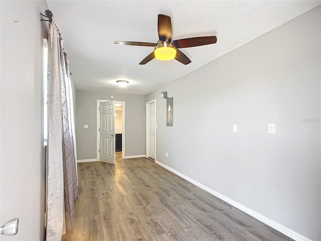empty room featuring hardwood / wood-style flooring and ceiling fan