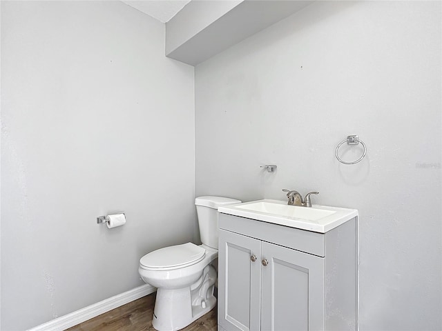 bathroom featuring vanity, hardwood / wood-style floors, and toilet