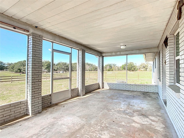 unfurnished sunroom with a rural view