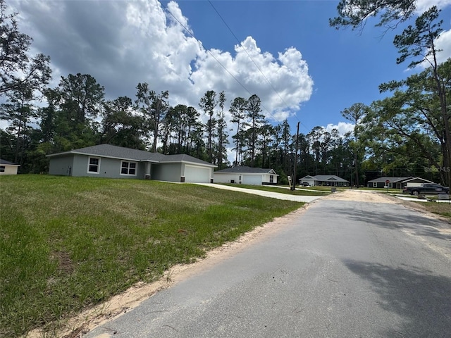 9971 N Bamboo Way, Citrus Springs, FL 34434 - view of front facade with driveway, an attached garage, and a front yard