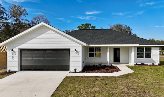 ranch-style house featuring driveway, an attached garage, roof with shingles, and a front yard