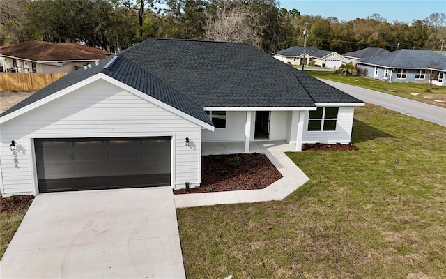 modern farmhouse featuring an attached garage, a front lawn, driveway, and roof with shingles