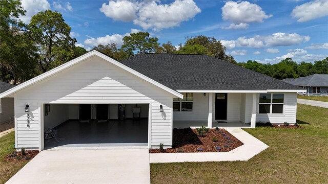 8295 SE 159th Ln, Summerfield, FL 34491 - view of front of property featuring a front yard, a garage, concrete driveway, roof with shingles, and a porch