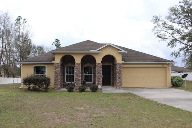 view of front of home with a garage and a front yard