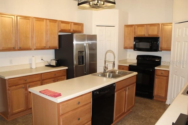 kitchen with sink, a center island with sink, and black appliances