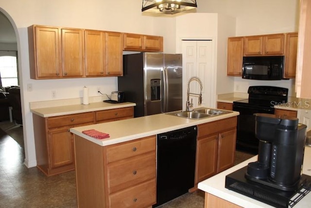 kitchen featuring sink, an island with sink, and black appliances