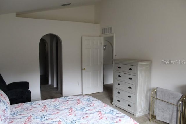 carpeted bedroom with vaulted ceiling