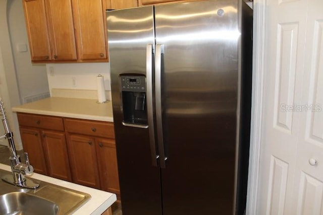 kitchen featuring sink and stainless steel fridge