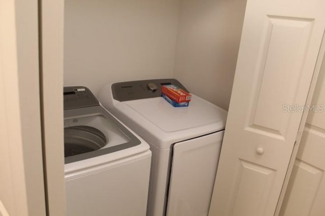 washroom with separate washer and dryer