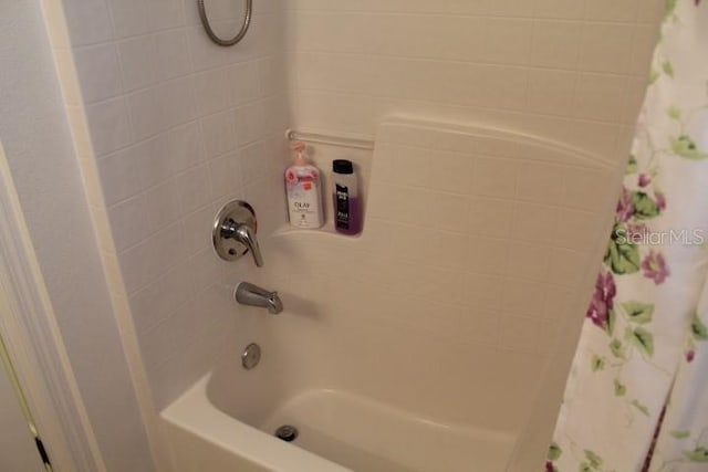 bathroom with shower / bath combo with shower curtain