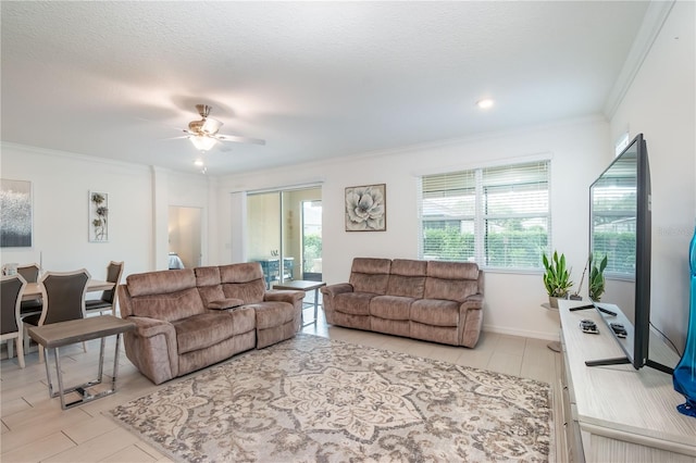 living room with crown molding, ceiling fan, plenty of natural light, and a textured ceiling