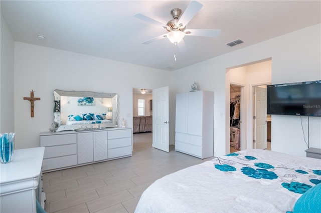 bedroom with a walk in closet and ceiling fan