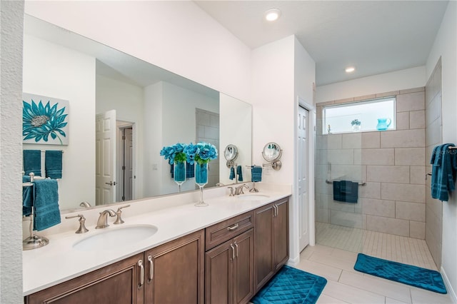 bathroom with vanity, tile patterned floors, and a tile shower