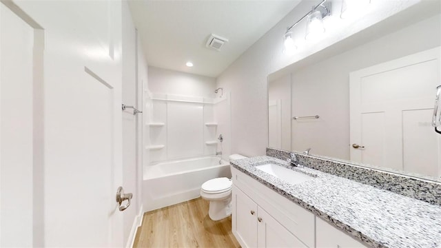 full bathroom with toilet, vanity, bathtub / shower combination, and hardwood / wood-style floors