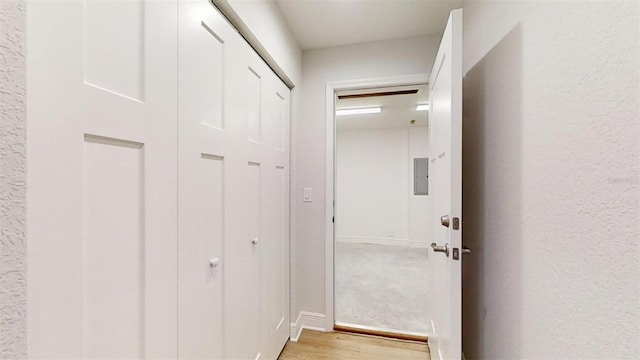 hall featuring electric panel and light wood-type flooring