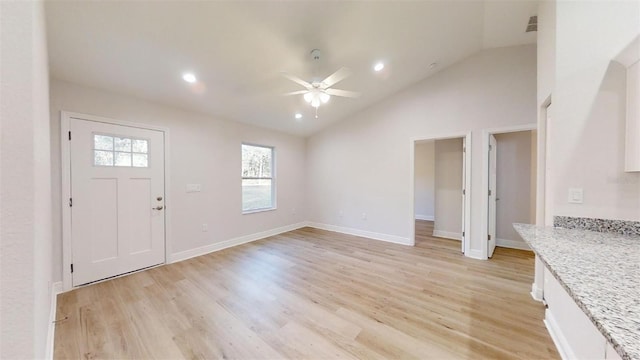 unfurnished living room with ceiling fan, high vaulted ceiling, and light hardwood / wood-style floors