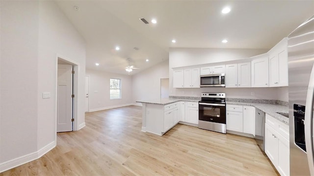 kitchen with white cabinetry, light stone counters, light hardwood / wood-style flooring, appliances with stainless steel finishes, and kitchen peninsula