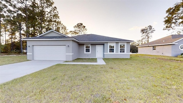 single story home with a garage and a lawn