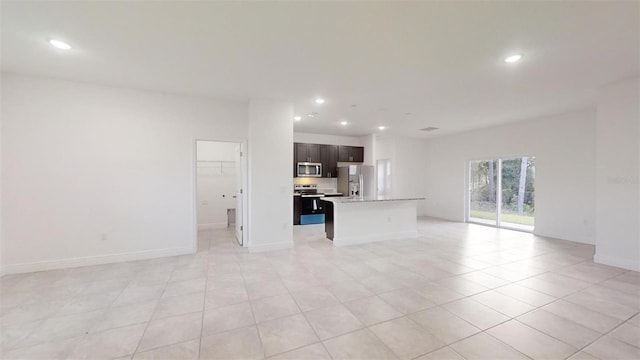 unfurnished living room featuring light tile patterned floors