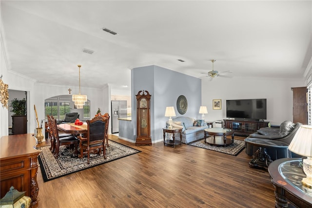 living room with lofted ceiling, ceiling fan with notable chandelier, wood-type flooring, and ornamental molding