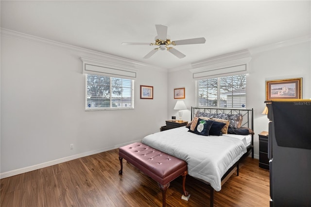 bedroom with hardwood / wood-style flooring, ornamental molding, and ceiling fan