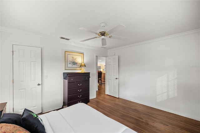 bedroom with hardwood / wood-style flooring, ornamental molding, and ceiling fan