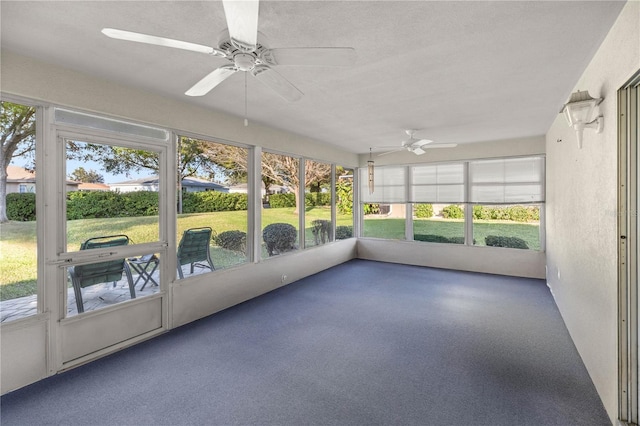 unfurnished sunroom featuring ceiling fan