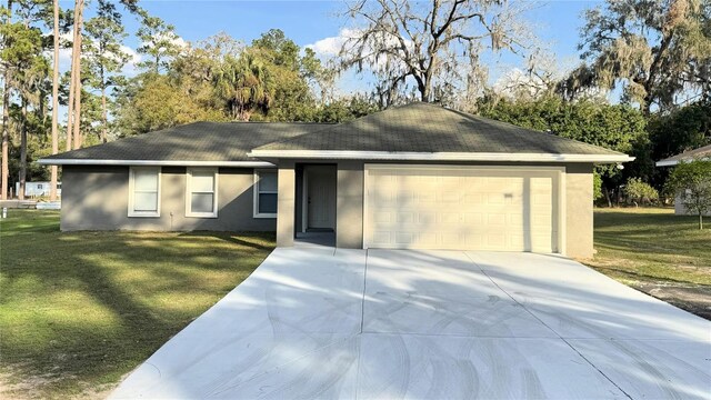 ranch-style home featuring a garage and a front lawn