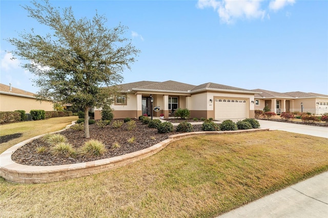 view of front of property with a garage and a front yard