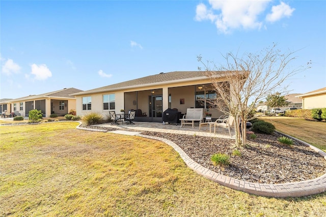 back of house featuring a patio area and a lawn