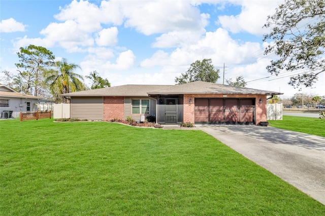 ranch-style house with a garage and a front lawn