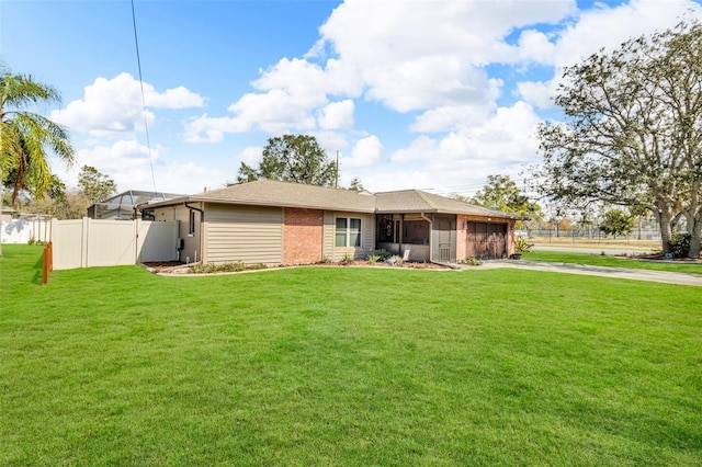 rear view of house featuring a garage and a lawn