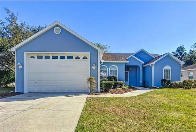 ranch-style home featuring a garage and a front lawn