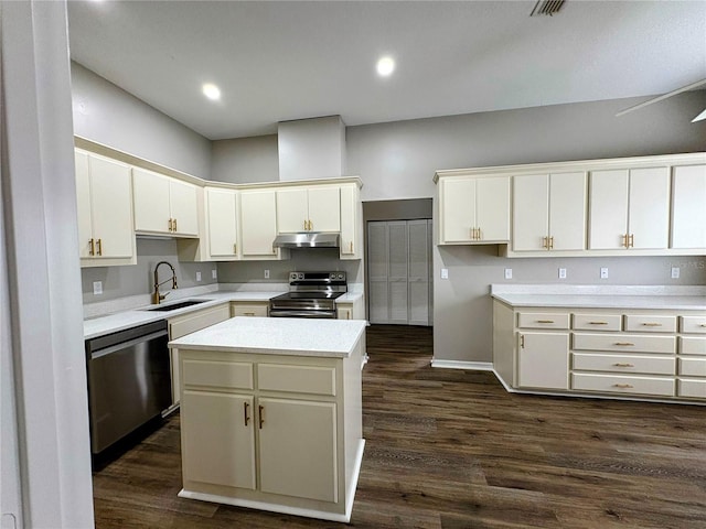 kitchen with a center island, appliances with stainless steel finishes, sink, and dark hardwood / wood-style floors