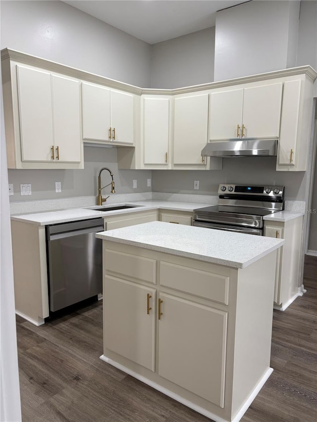 kitchen with sink, a center island, dark hardwood / wood-style flooring, stainless steel appliances, and white cabinets