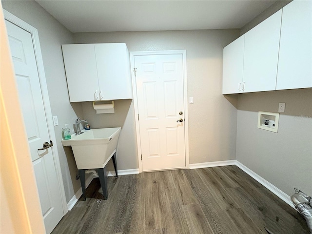 clothes washing area featuring hookup for a washing machine, dark wood-type flooring, and cabinets