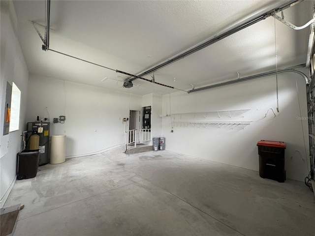 garage featuring a garage door opener and water heater