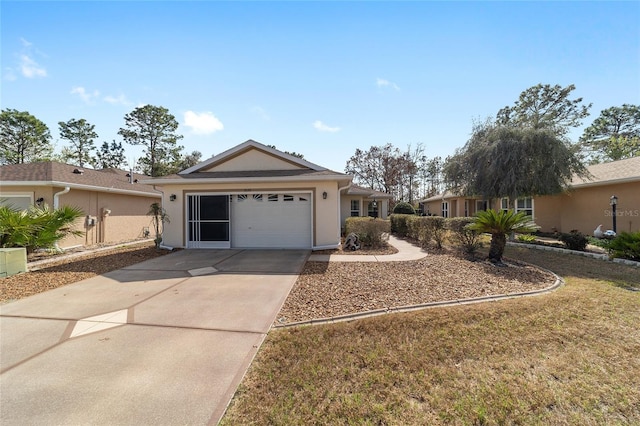 ranch-style home featuring driveway, an attached garage, and stucco siding