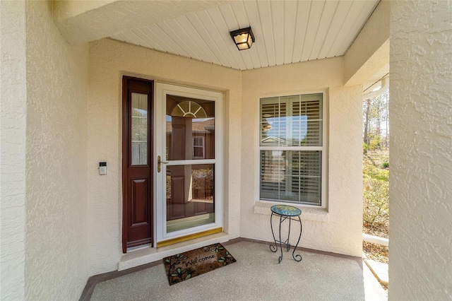 property entrance featuring stucco siding