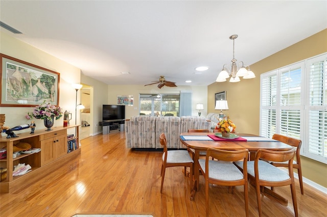 dining room with baseboards, visible vents, plenty of natural light, and light wood finished floors