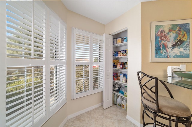 office space featuring baseboards and tile patterned floors