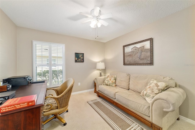 home office with light carpet, ceiling fan, and baseboards