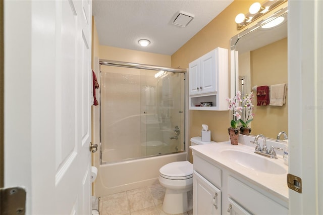 bathroom featuring visible vents, toilet, shower / bath combination with glass door, tile patterned floors, and vanity