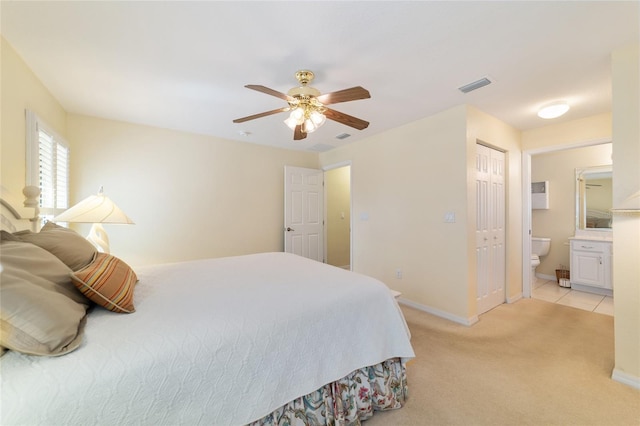 bedroom featuring visible vents, light carpet, connected bathroom, ceiling fan, and baseboards