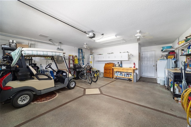 garage with a garage door opener, gas water heater, and a workshop area