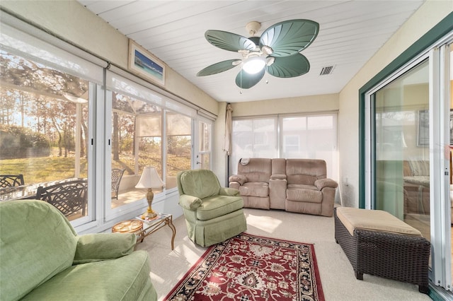 sunroom with visible vents, plenty of natural light, and ceiling fan