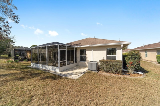 back of property featuring stucco siding, a yard, and central AC unit