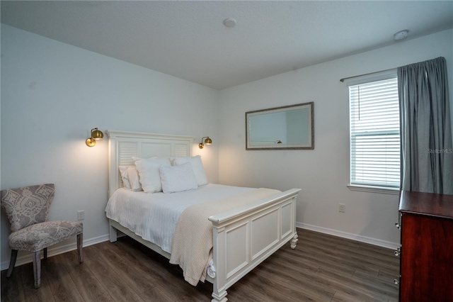 bedroom with dark hardwood / wood-style floors