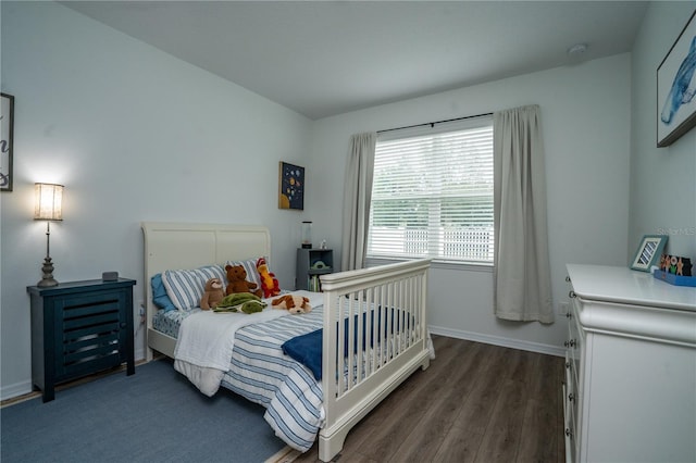 bedroom featuring dark hardwood / wood-style flooring